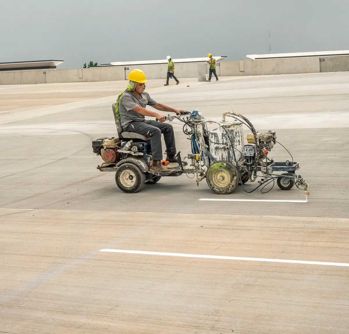 striping parking lot lines on the rooftop level of 4-story parking deck at junction 49