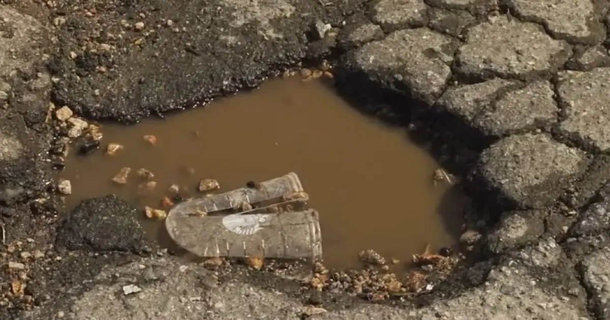 Boots submerged in a muddy pothole