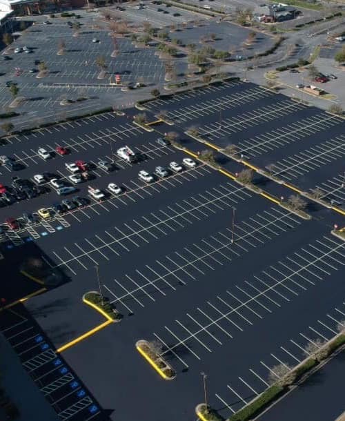 Empty parking lot with few cars